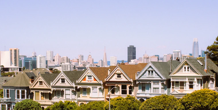 a row of houses with a city in the background