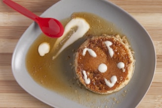 Traditional dessert of pudim de leite with caramel sauce on a white plate.