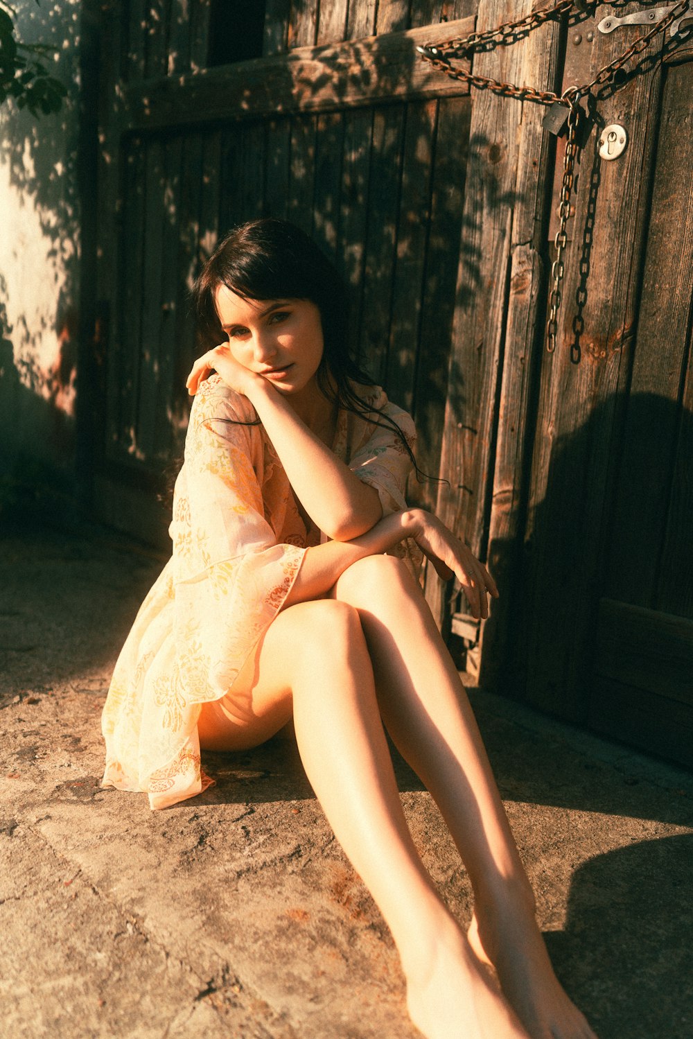 a woman in a yellow dress sitting on the ground