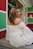 a woman in a white dress sitting on a step