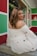 a woman in a white dress sitting on a step