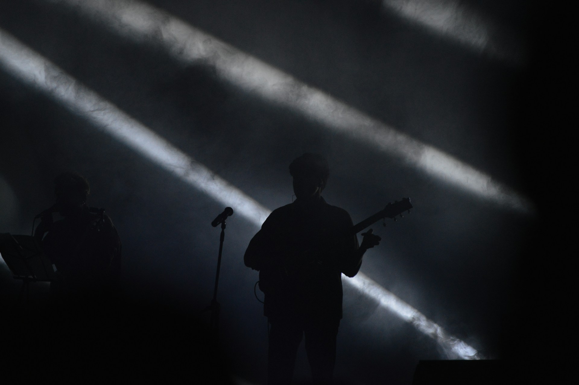 a man standing in front of a microphone on a stage