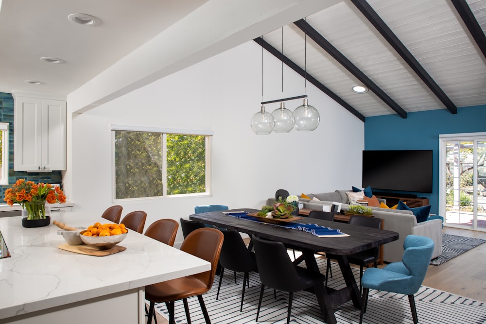 a kitchen with a table and chairs and a television