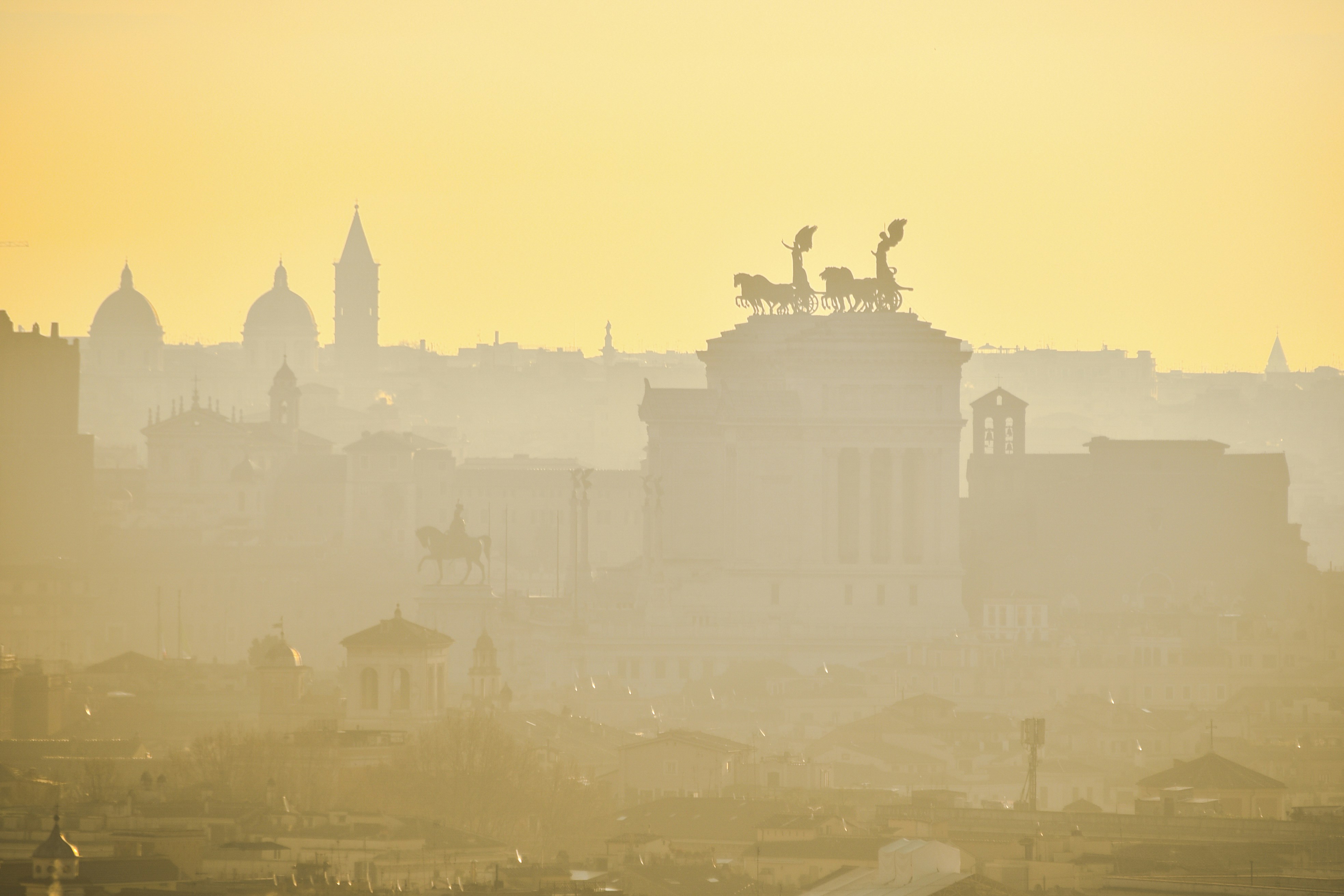a view of a city with a statue on top of it