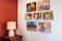 A vibrant wall display featuring colorful photographic prints in a cozy living room.