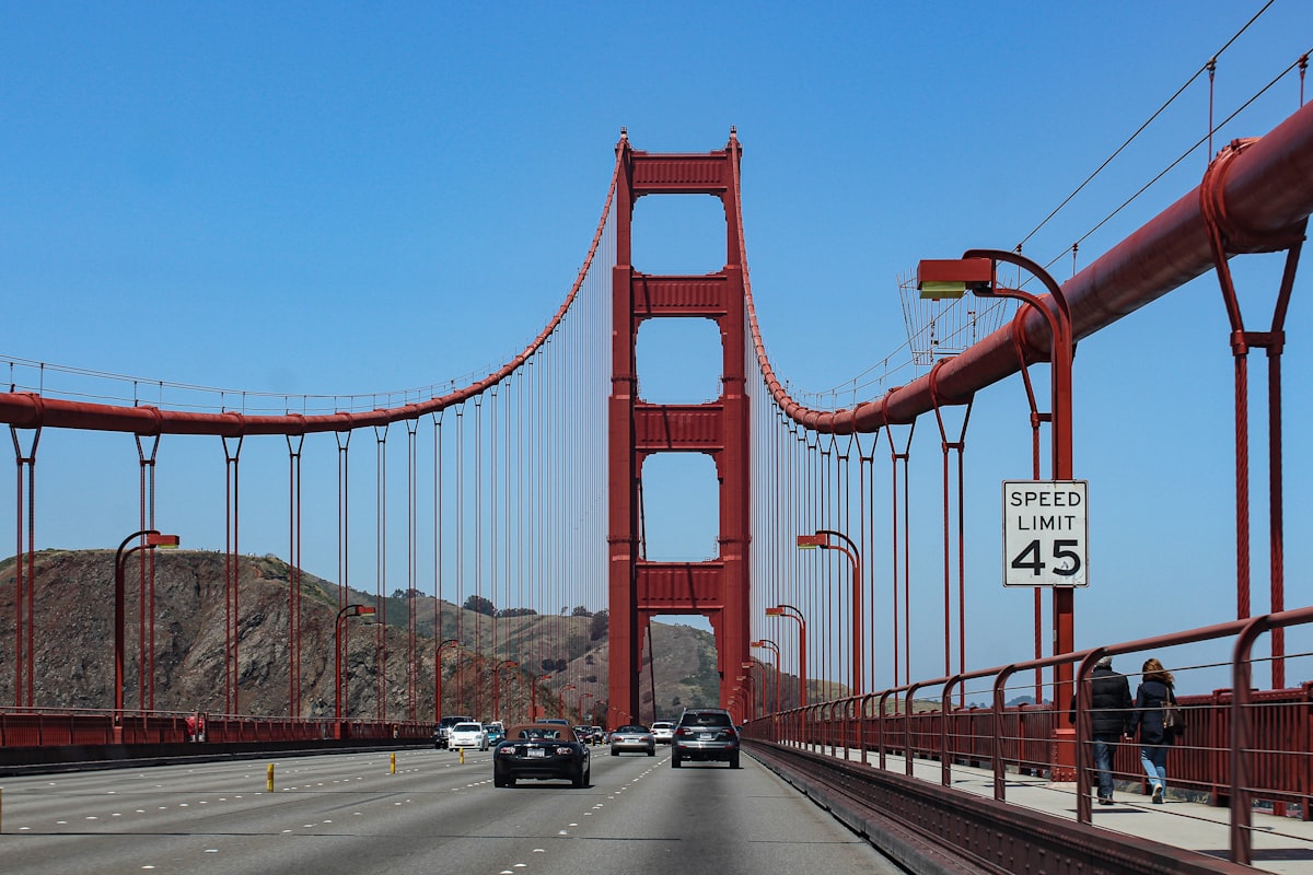 A car approaching the Golden Gate Bridge with a road sign, San Francisco