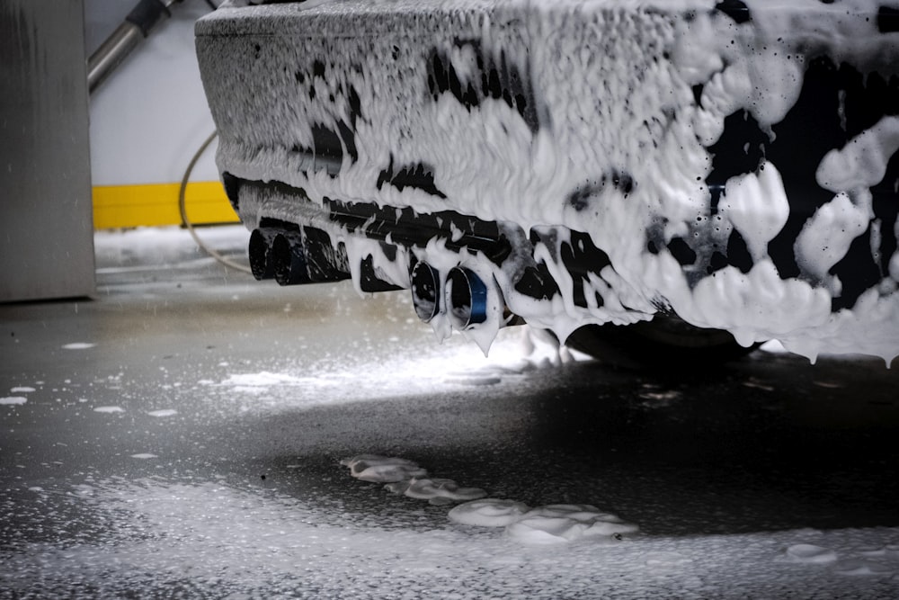 a close up of a car tire covered in snow