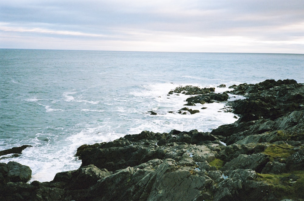 a view of the ocean from a rocky cliff