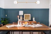 A stylish dining table set with chic candle holders and decorative bowls.
