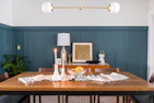 A stylish dining table set with chic candle holders and decorative bowls.