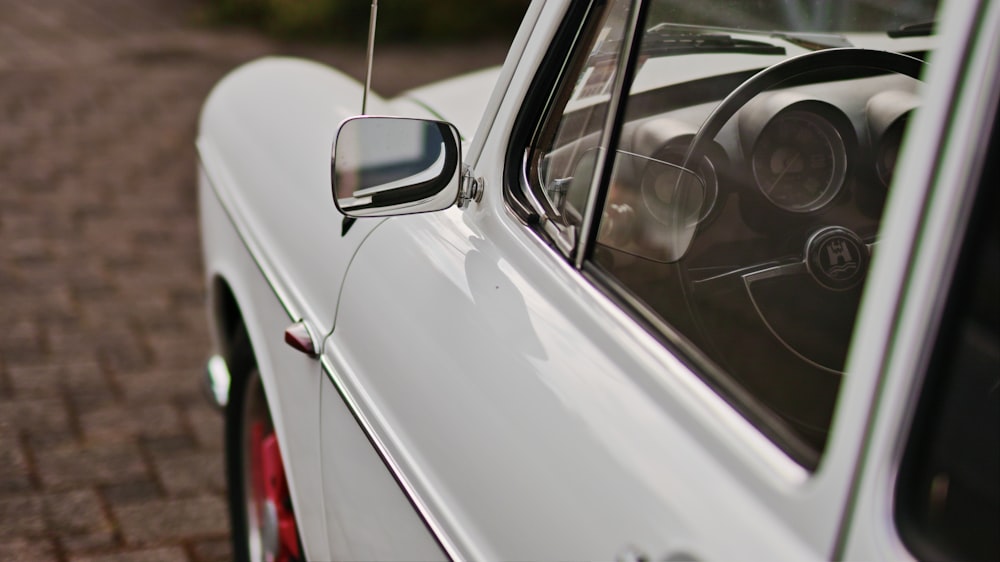 a white car parked on a brick road