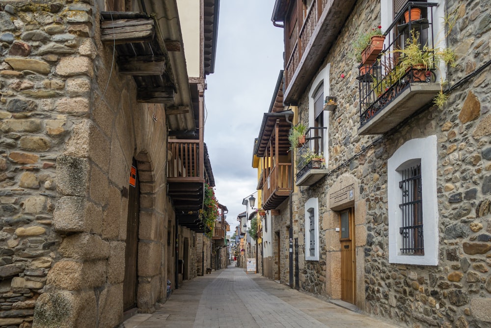 a narrow street with stone buildings on both sides