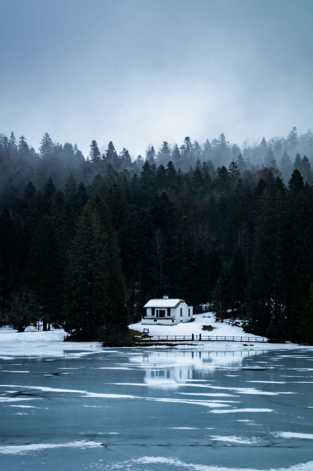 a house on the shore of a frozen lake