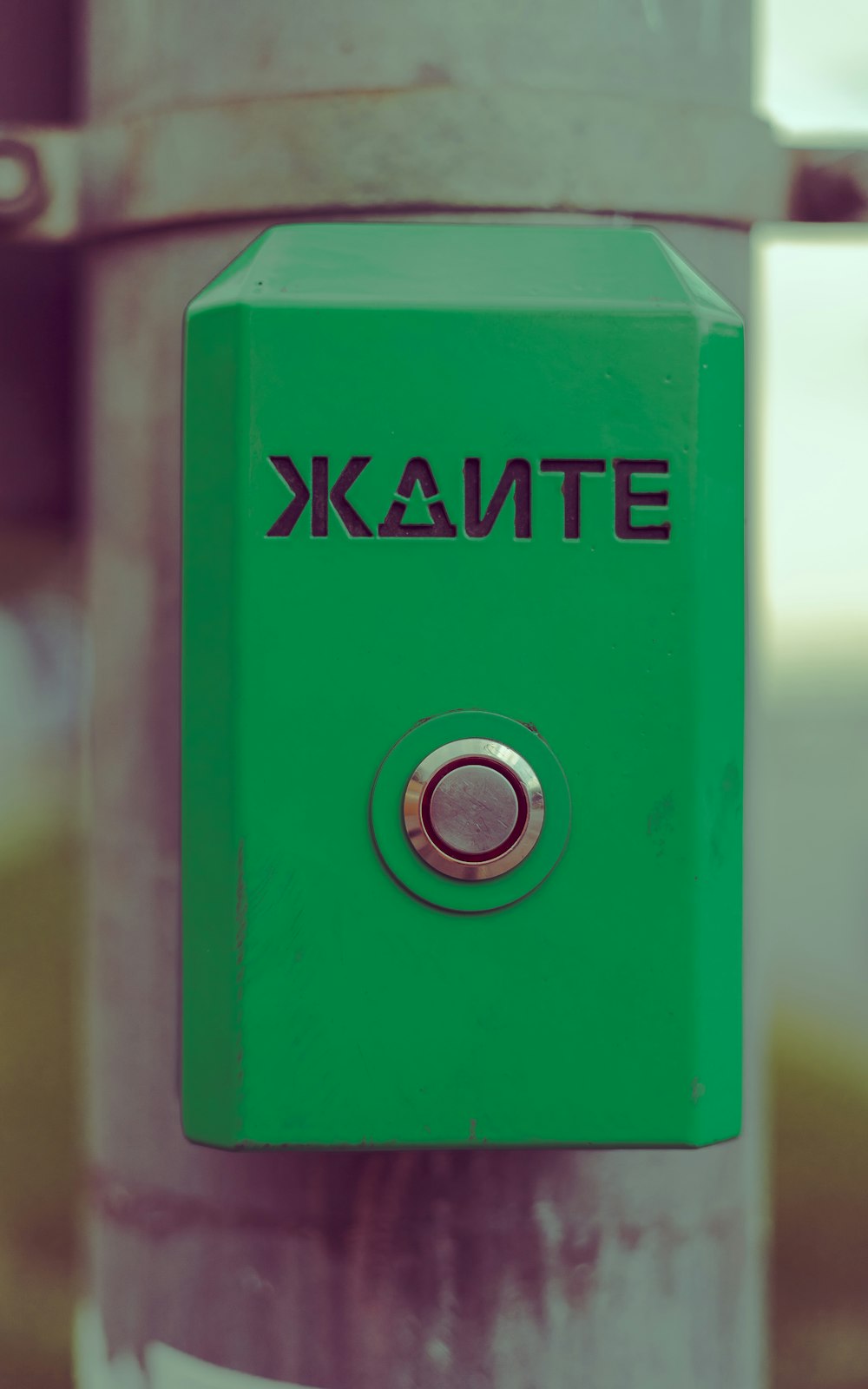 a close up of a green box on a pole