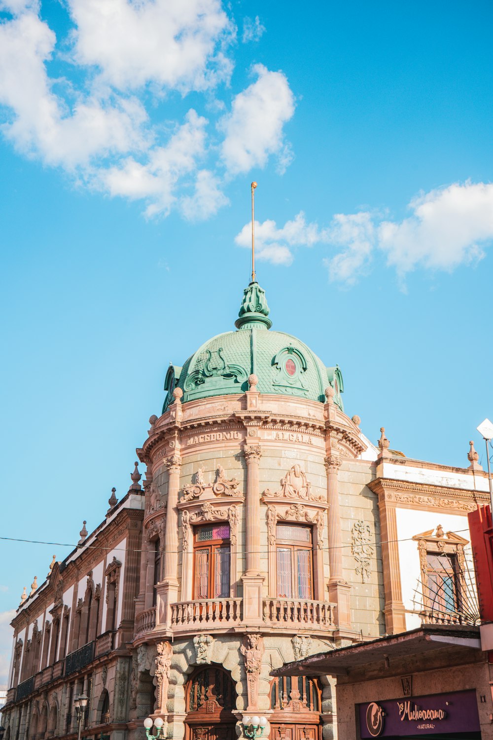 a large building with a green dome on top