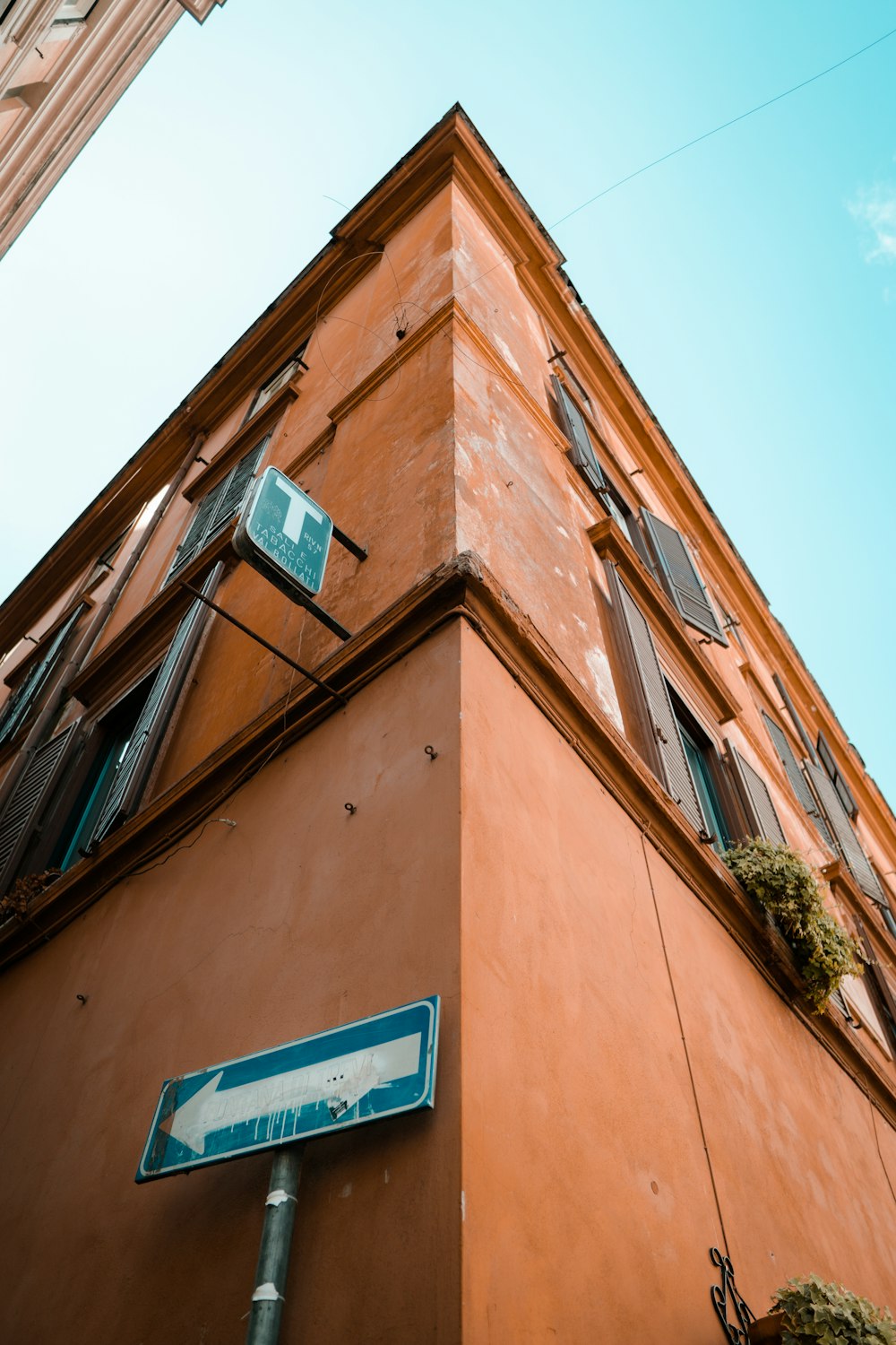 a tall building with a street sign attached to it's side