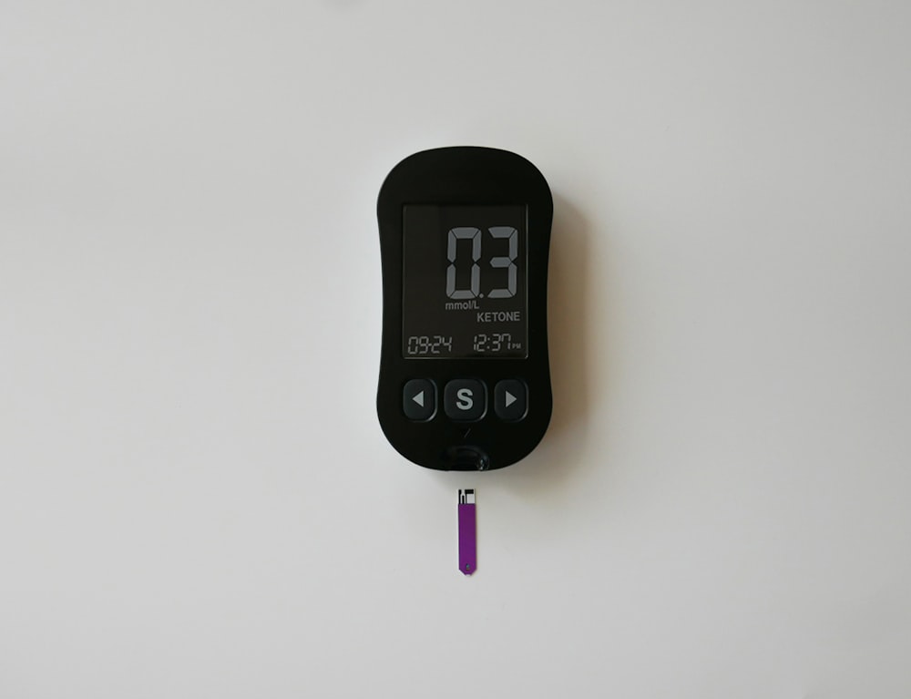 a digital thermometer on a white wall