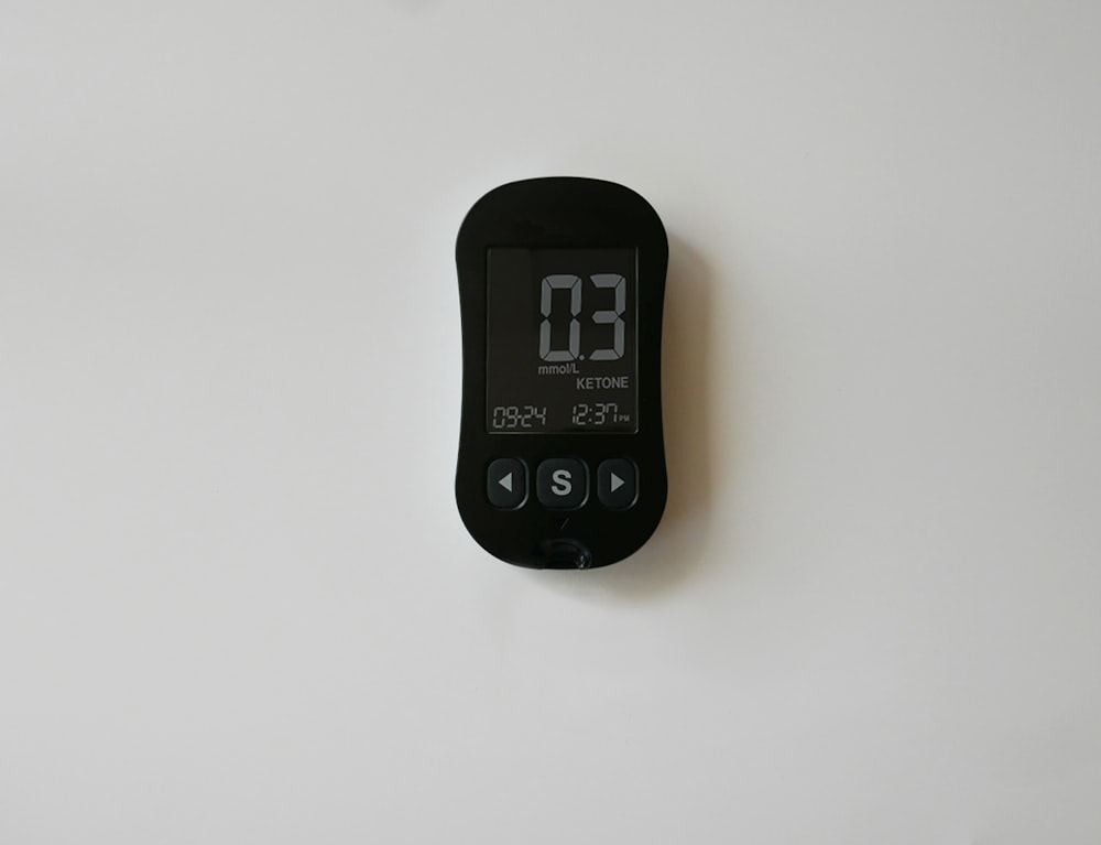 a digital thermometer on a white wall