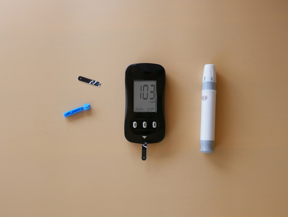 a digital thermometer and a pen on a table