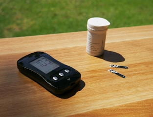 A modern blood glucose meter with a digital screen and test strips ready.