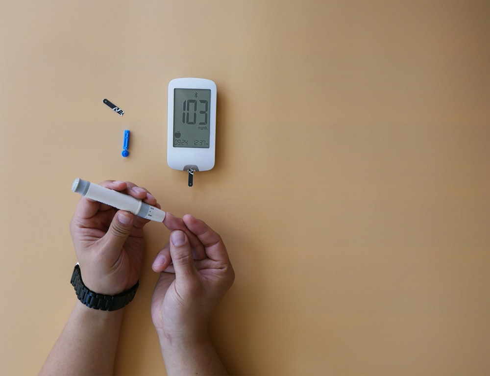 a person holding a thermometer next to a thermometer