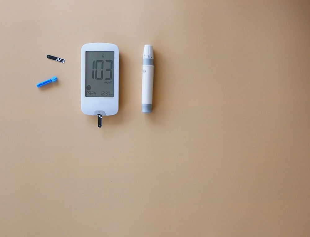 a thermometer and a pen on a table