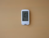 a digital thermometer is displayed on a wall