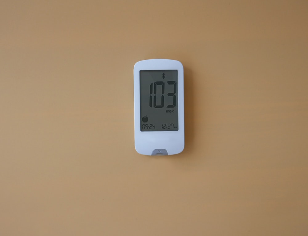 a digital thermometer is displayed on a wall