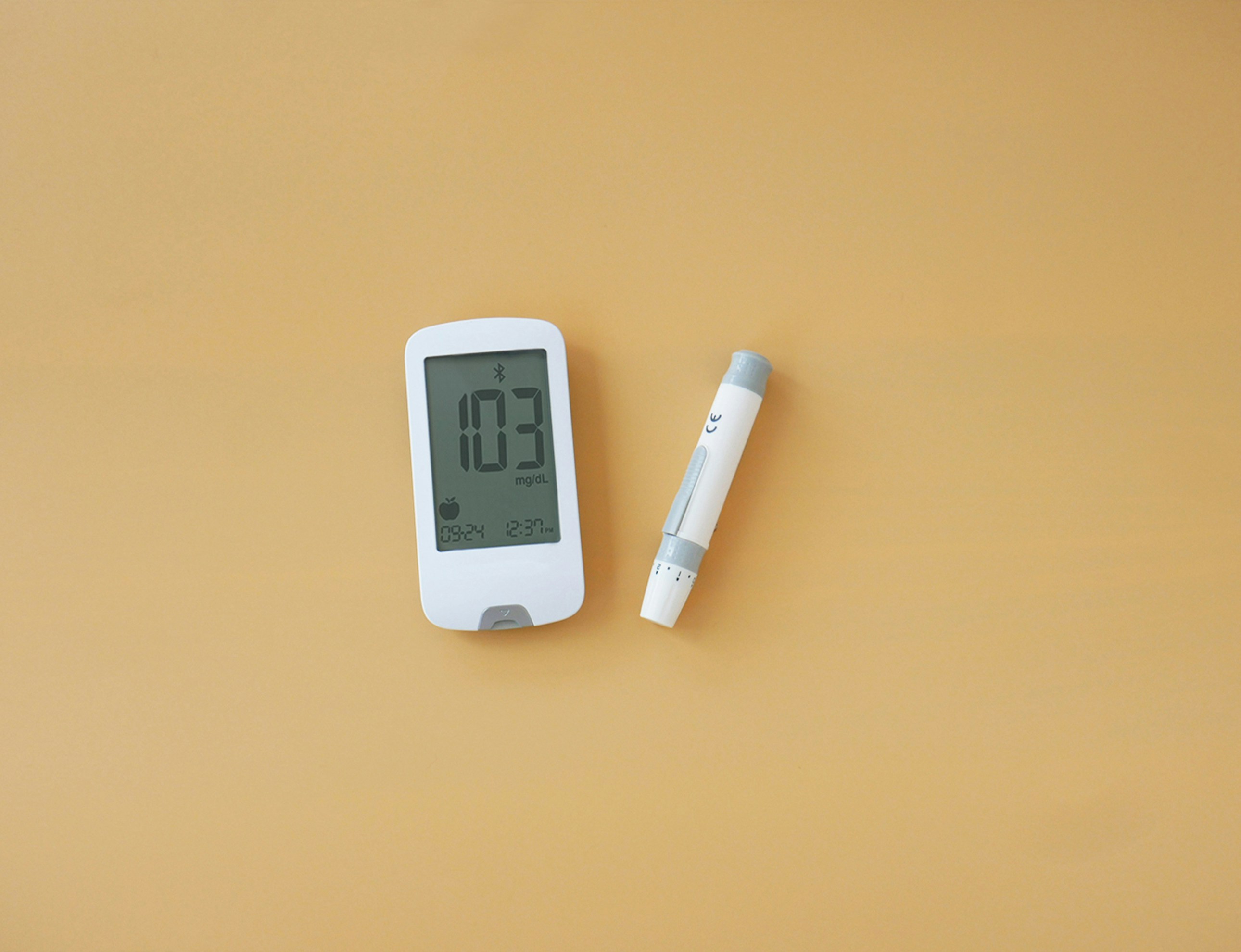 a thermometer and a pen on a yellow surface