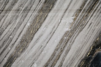 Quartzite slab featuring a sleek, minimalist pattern with fine lines and soft contrasts.