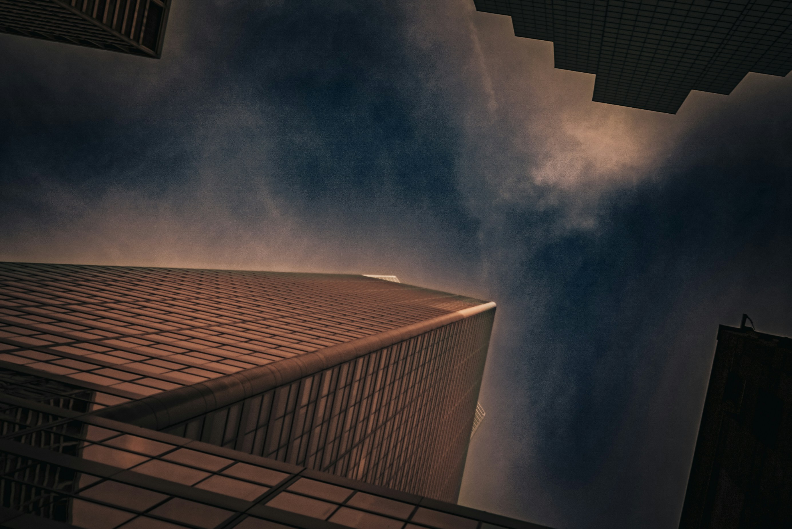 A tall building sitting under a cloudy sky photo – Free City Image on ...