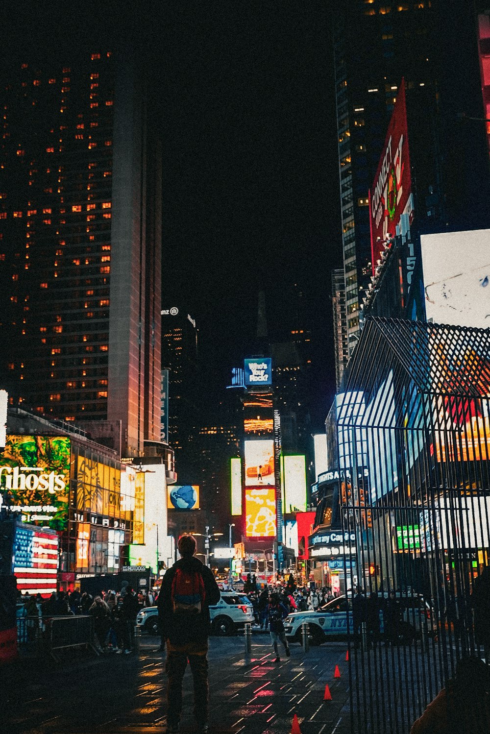 a man walking down a street at night