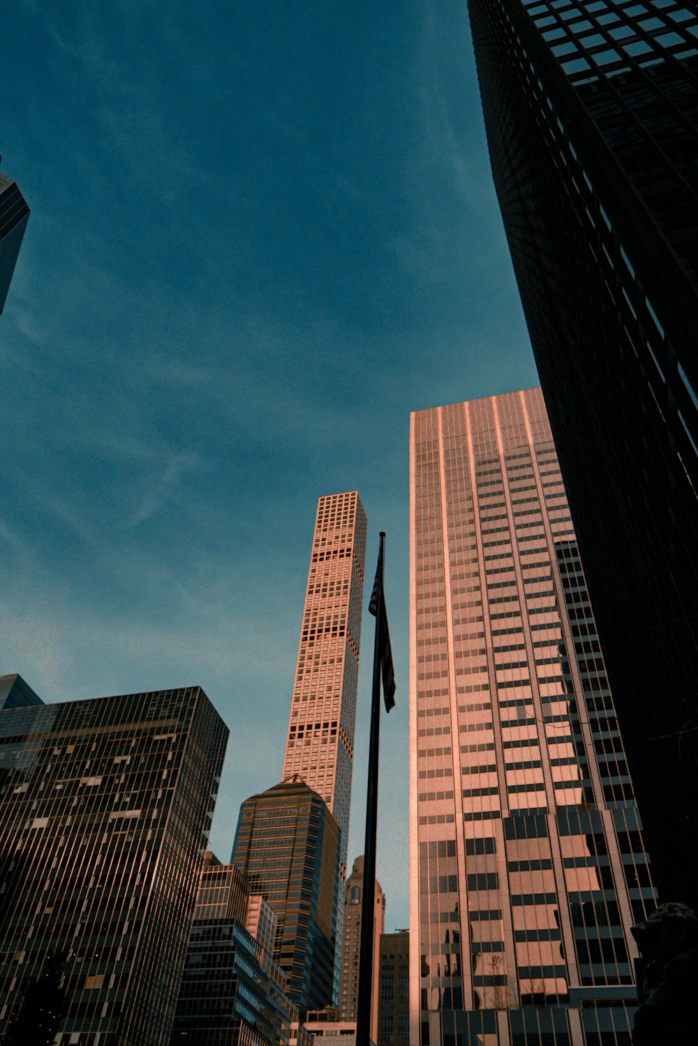 a city street with tall buildings in the background