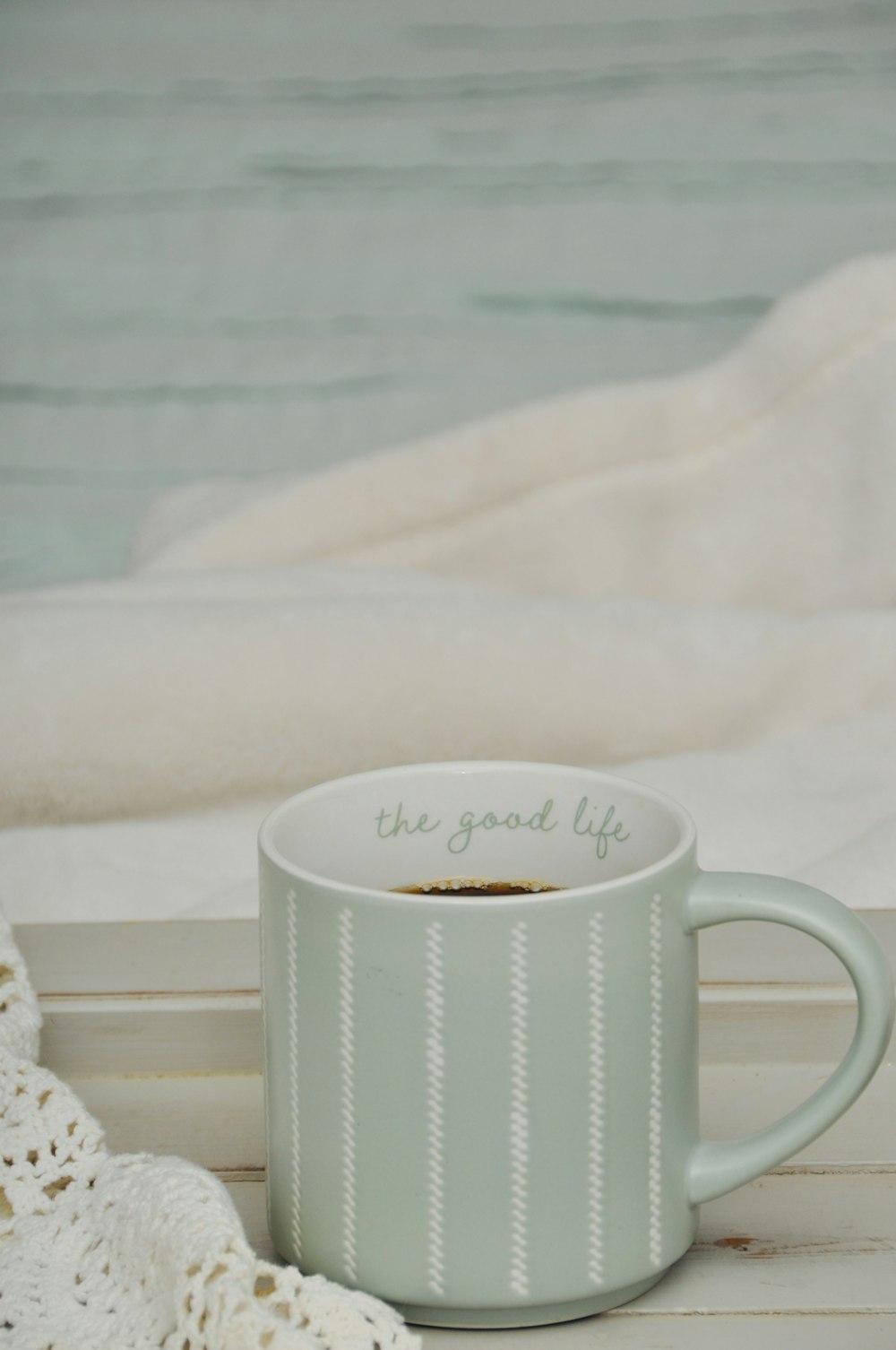 a cup of coffee sitting on top of a table