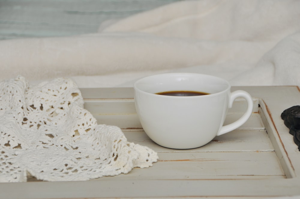 a cup of coffee sitting on top of a tray