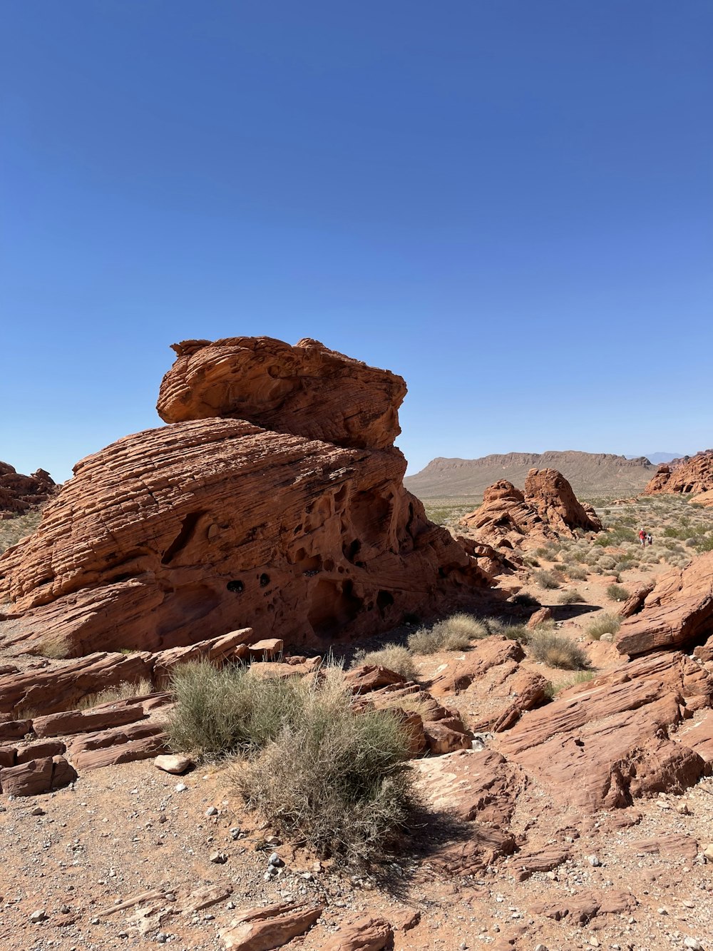 a large rock formation in the middle of a desert