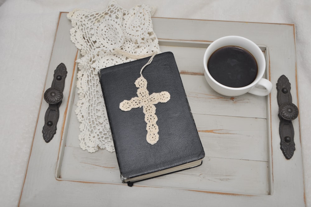 a cup of coffee and a book on a table