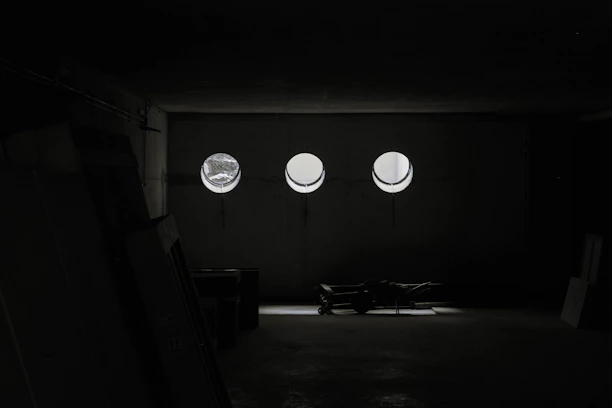 A spacious, organized storage facility with neatly stacked furniture and boxes under soft lighting.