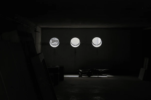 A professional mover carefully packing a cozy living room, with bright natural light streaming through the window.