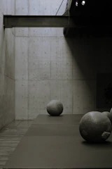 Interior shot featuring minimalist furniture and natural stone walls.