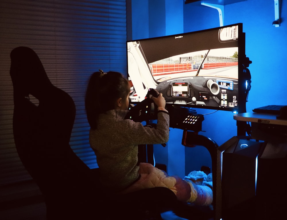 a person sitting in a chair in front of a tv