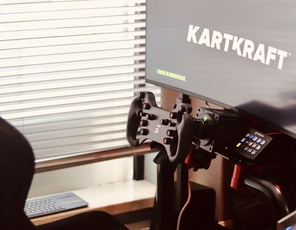 a computer monitor sitting on top of a desk next to a keyboard