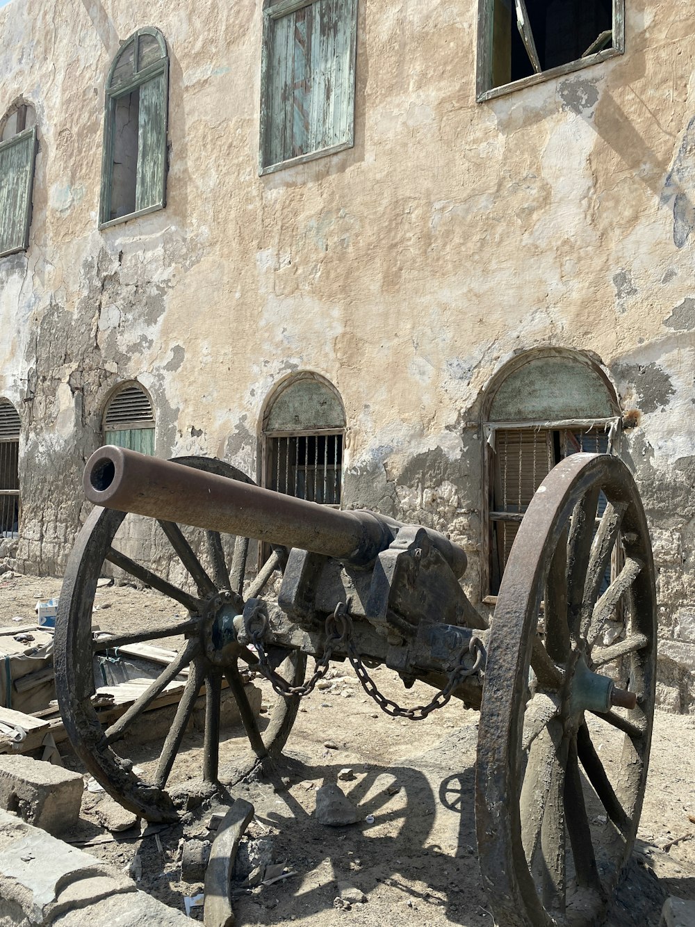 an old cannon sitting in front of a building