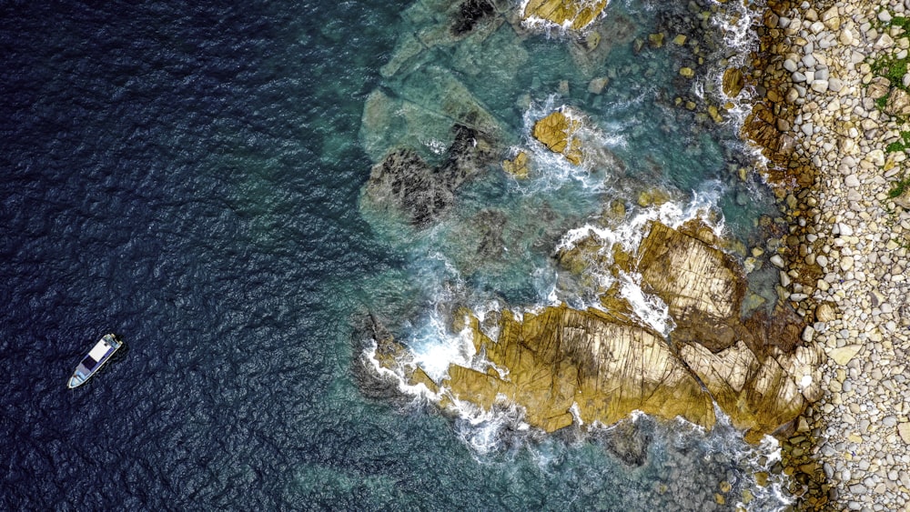 an aerial view of a boat on the water