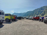 Wide shot of a buggy rally with colorful vehicles lined up.