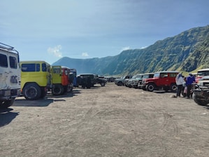 A lineup of diverse vehicles including SUVs, trucks, and motorcycles waiting for service.