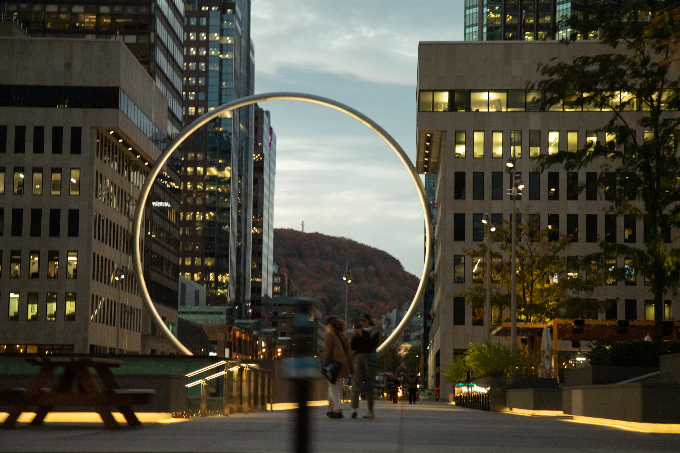 Montréal at dusk with the Mont-Royal cross visible above downtown towers