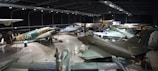 A modern hangar showcasing various aircraft.