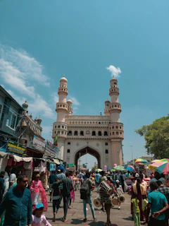 A vibrant street scene in Riyadh showcasing traditional architecture and bustling market life under a clear blue sky.