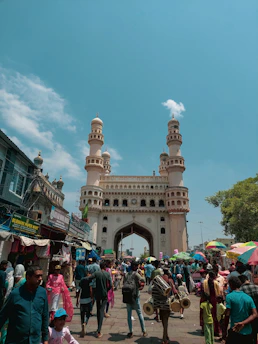 A vibrant street scene in Riyadh showcasing traditional architecture and bustling market life under a clear blue sky.
